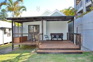 a wooden deck with a picnic table on a house at Rockleigh in South West Rocks