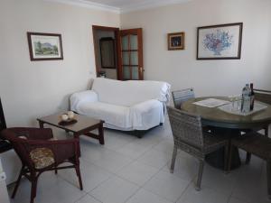 a living room with a couch and a table and chairs at Apartamento Esperanto in Las Lagunas