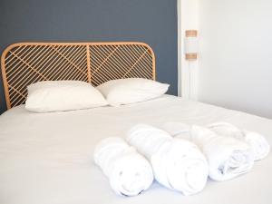 uma pilha de toalhas brancas numa cama em Le Rooftop - Vue incroyable sur le Théatre Antique em Orange