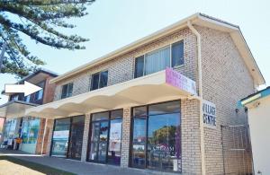 a store front of a brick building with a sign on it at Village Centre 3 South West Rocks in South West Rocks