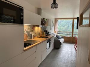 a kitchen with a sink and a stove top oven at Charmant appartement 3 pièces - 6 personnes in Châtel