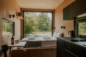 a small bedroom with a bed and a window at Rest Place Mszczonów in Mszczonów
