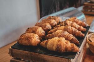 a tray of croissants and other pastries on a table at Sancy Resort in Chambon-sur-Lac