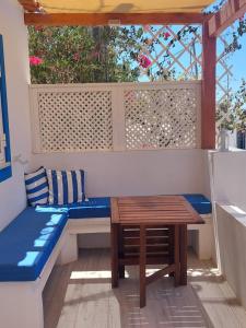 a porch with a bench and a table at Casa Azul do Cerro in Campeiros
