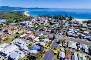 an aerial view of a suburb with a yellow arrow at Sunshine Cottage - Bring your own linen. in South West Rocks