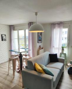 salon z kanapą i stołem w obiekcie Le Manhattan 3*, Lumineux , calme vue sur le lac w mieście Bruges