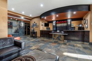 a lobby with a leather couch and a bar at Best Western Bonnyville Inn & Suites in Bonnyville