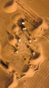 an aerial view of a desert with footprints in the sand at Sunrise Sahara Camp in Merzouga