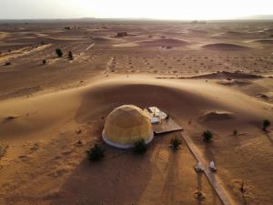 an aerial view of a desert with a tent at Sunrise Sahara Camp in Merzouga
