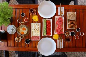 Elia İmroz Hotel في غوكجيادا: طاولة خشبية عليها صحون طعام