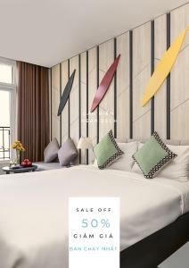 a bedroom with a bed with colorful arrows on the headboard at Le House Boutique Hotel in Danang