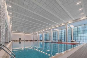 a large swimming pool with a large ceiling at Hyatt Regency Baku in Baku