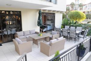 a patio with chairs and tables and an umbrella at Luxury 2 bedroom apartment in Cape Town in Cape Town