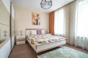 a bedroom with a bed and a large window at MARSY in Sandanski
