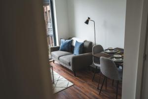 a living room with a couch and a table at Modern 1-Bed Apartments - New - City Centre - FREE Wi-Fi - in Sheffield