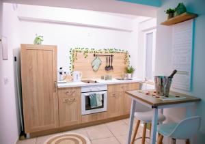 a kitchen with a sink and a stove and a table at Monti-love in Montivilliers