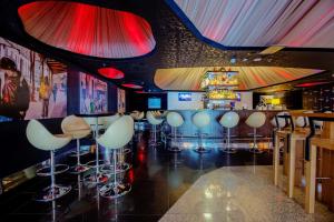a bar with a bunch of stools in a room at Andersia Hotel & Spa Poznan, a member of Radisson Individuals in Poznań