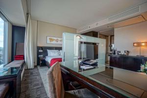 a hotel room with a desk and a bed at Andersia Hotel & Spa Poznan, a member of Radisson Individuals in Poznań