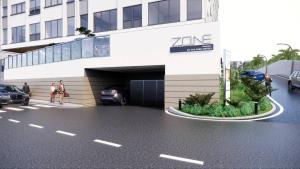 a rendering of a parking garage in front of a building at Zone By The Park Gopalpur in Gopālpur