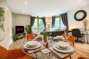 a living room with a glass table and chairs at Campbell Park Apartment - City Centre - Free Parking, Balcony, Super-Fast Wifi and Smart TV with Netflix by Yoko Property in Milton Keynes