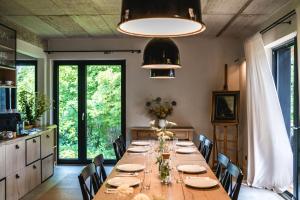 a dining room with a long table and chairs at Witoszyn28 in Kazimierz Dolny