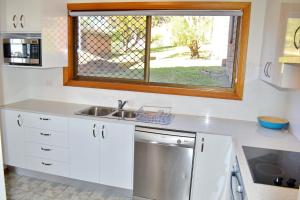 a kitchen with a sink and a window at Seaview Townhouse 3 in South West Rocks