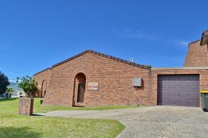 a brick building with a garage and a driveway at Seaview Townhouse 3 in South West Rocks