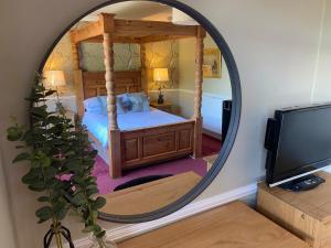 a bedroom with a bed and a mirror at Lonsdale House in Windermere