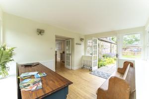 a living room with a table and a couch at Garden Cottage in Gargunnock