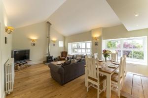 a living room with a couch and a table at Garden Cottage in Gargunnock