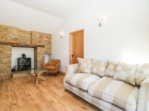 a living room with a couch and a fireplace at Steel Works Farm in Ross on Wye
