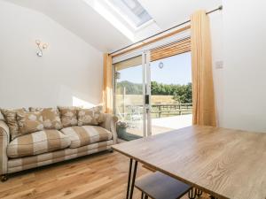 a living room with a couch and a table at Steel Works Farm in Ross on Wye