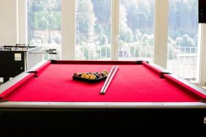 a red pool table with chopsticks on top of it at Ferienhaus Lacher in Baiersbronn
