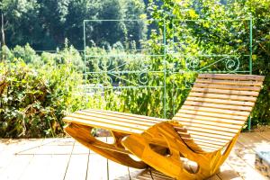 a wooden bench sitting on top of a patio at Ferienhaus Lacher in Baiersbronn