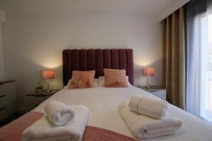 A bed or beds in a room at TESS Villa Le Clos Fleury
