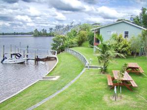a boat is docked at a house on the water at Coast and Country Cabin 2 in Pelican Island