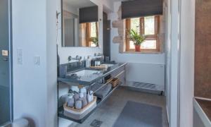 a bathroom with a sink and a mirror at Zen Rocks Resort in Kalianeika +70 photos