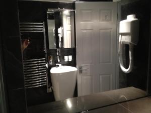 a bathroom with a white sink and a mirror at Holiday Lets London in London