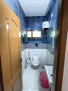 a small bathroom with a toilet and a sink at Coral Drive Villas -Your Private Beach Destination in Chennai