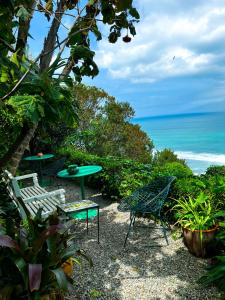 a patio with chairs and a table and the ocean at Aux 3 Portes in Tangier