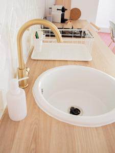 a bathroom sink with a faucet on a wooden counter at Le Terracotta - Appartement centre ville avec balcon in Orange