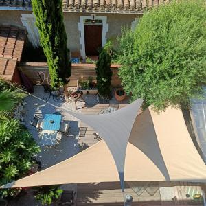 an overhead view of a patio with a tent and trees at Entre Bastide et Cité et son rooftop in Carcassonne +32 photos