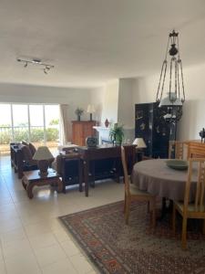 a living room with a table and a dining room at Appartement Praia da Luz - 2 Personnes - Vue mer in Luz