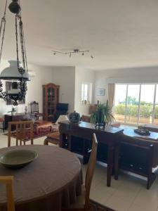 a living room with a table and a dining room at Appartement Praia da Luz - 2 Personnes - Vue mer in Luz