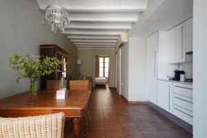 a dining room with a table and a kitchen at numa I Seda Apartments in Barcelona