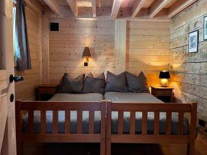 a bedroom with a bed in a wooden cabin at Enjoy Eco Lodge in Onhaye