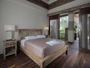a bedroom with a large bed and a large window at Villa Rumah Pantai Bali in Selemadeg +69 photos