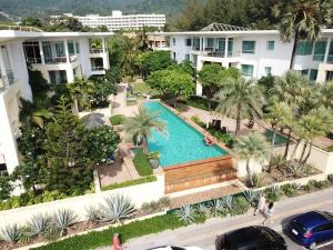 an overhead view of a pool with palm trees and buildings at Karon Sea View Beach Apartment in Karon Beach