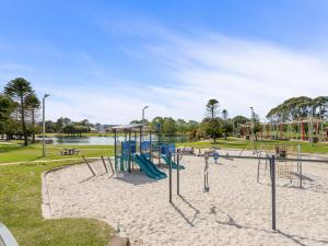 a playground in a park next to a body of water at Yaran Suites in Rockingham