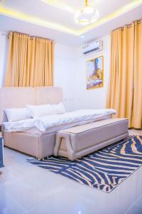 a bedroom with two beds and a rug at Plistbooking Xive 3 bedroom Luxury Abuja Apartment in Abuja